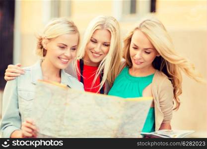 holidays and tourism concept - beautiful blonde women with tourist map in the city