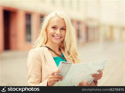holidays and tourism concept - beautiful girl with tourist map in the city