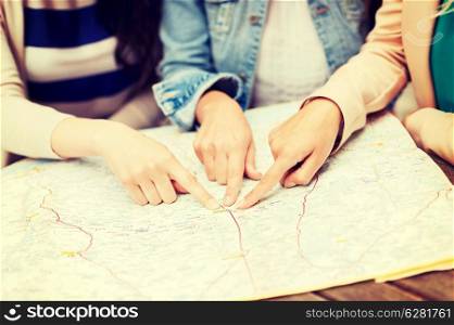 holidays and tourism concept - women with tourist map in the city