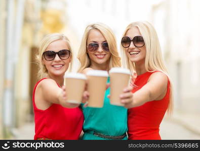 holidays and tourism, friends, blonde girls concept - beautiful women with takeaway coffee cups in the city