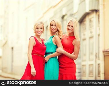 holidays and tourism, friends, hen party and blonde girls concept - three beautiful women in the city