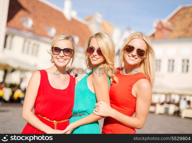 holidays and tourism, friends, hen party, blonde girls concept - three beautiful women in the city