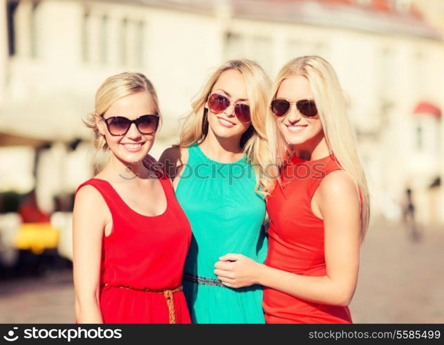 holidays and tourism, friends, hen party, blonde girls concept - three beautiful women in the city