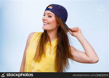 Holidays and vacation. Lovely trendy urban style girl in jeans cap. Portrait of long haired smiling attractive teenage woman.. Portrait of joyful trendy girl.