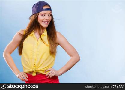 Holidays and vacation. Lovely trendy urban style girl in jeans cap. Portrait of long haired smiling attractive teenage woman.. Portrait of joyful trendy girl.