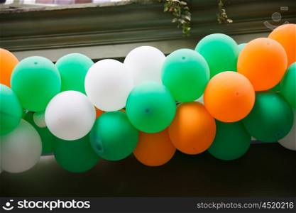 holidays, birthday, celebration and decoration concept - close up of colorful balloons garland