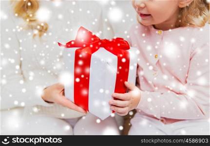 holidays, birthday, christmas, children and family concept - close up of mother and little girl with gift box at home