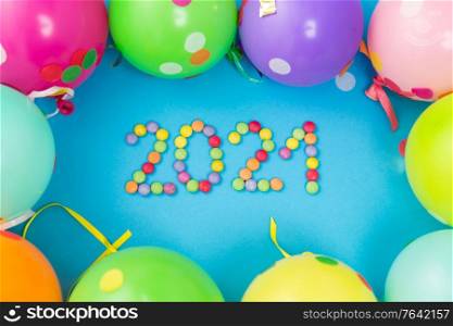 holidays, celebration and decoration concept - 2021 new year party date with colorful balloons on blue background. new year 2021 party date with balloons