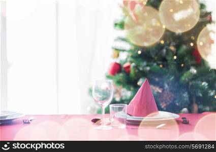 holidays, celebration and home concept - close up of room with christmas tree and decorated table