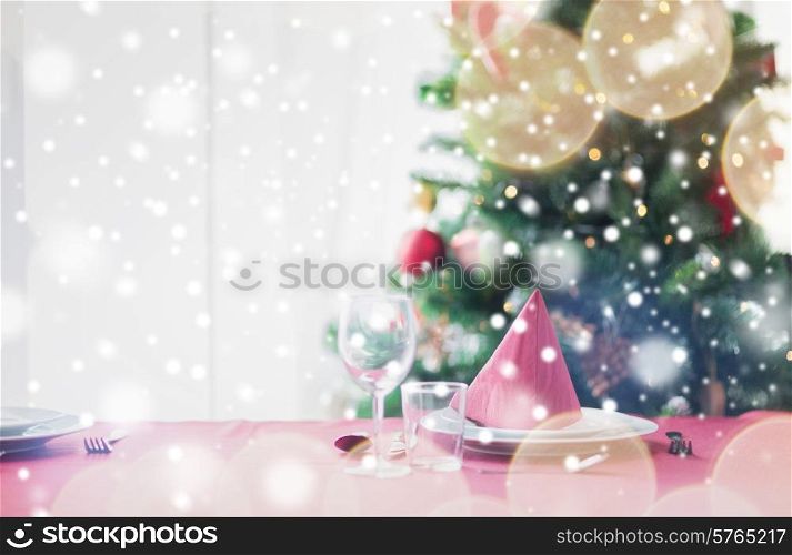holidays, celebration and home concept - close up of room with christmas tree and decorated table