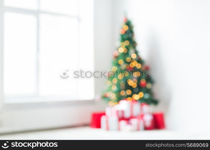 holidays, celebration and home concept - living room with christmas tree and presents background