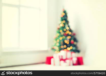 holidays, celebration and home concept - living room with christmas tree and presents background