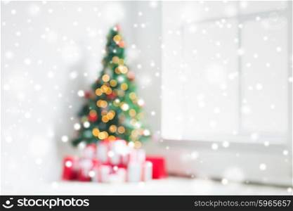 holidays, celebration and home concept - living room with christmas tree and presents background