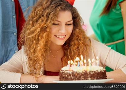 holidays, celebration and people concept - close up of happy redhead woman with candles burning on birthday cake at party. happy woman with candles on birthday cake at party