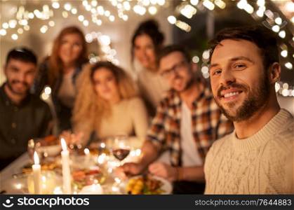 holidays, celebration and people concept - happy friends taking selfie at home christmas dinner party. friends taking selfie at christmas dinner party