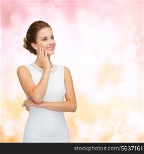 holidays, celebration, wedding and people concept - smiling woman in white dress wearing diamond ring over pink lights background