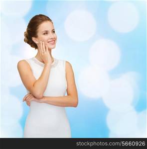 holidays, celebration, wedding and people concept - smiling woman in white dress wearing diamond ring over blue lights background