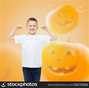holidays, childhood, happiness, gesture and people concept - smiling little boy in white blank shirt raising hands over halloween pumpkins background