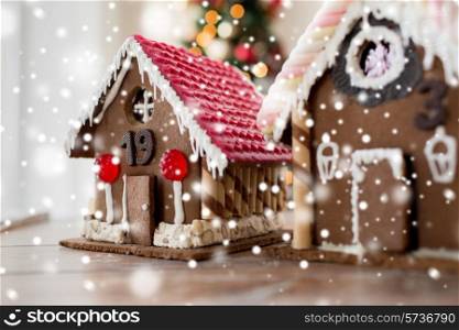 holidays, christmas, baking and sweets concept - closeup of beautiful gingerbread houses at home