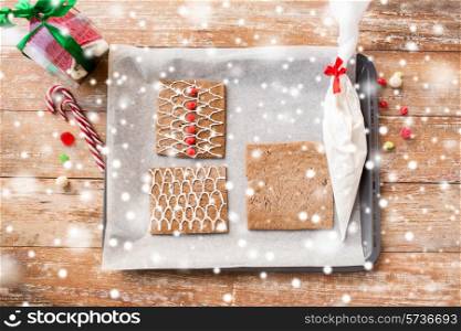 holidays, christmas, baking and sweets concept - closeup of gingerbread house details on pan