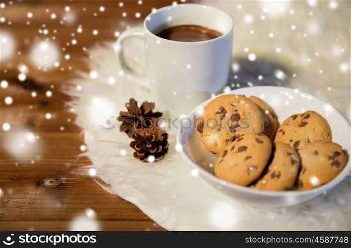 holidays, christmas, winter, food and drinks concept - close up of cups with hot chocolate or cocoa drinks and oat cookies on white fur rug