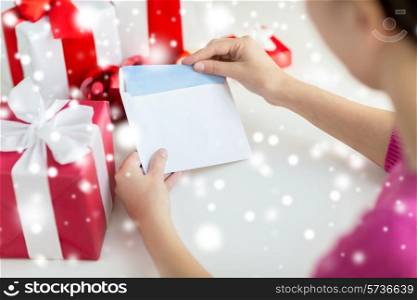 holidays, communication and people concept - close up of woman with letter and presents