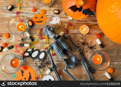 holidays concept - halloween decorations and candies wooden boards. halloween decorations and candies wooden boards