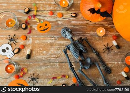 holidays concept - halloween decorations and candies wooden boards. halloween decorations and candies wooden boards