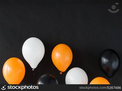 holidays, decoration and party concept - bunch of air balloons for halloween or birthday over black background. air balloons for halloween or birthday party