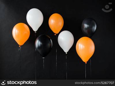 holidays, decoration and party concept - bunch of air balloons for halloween or birthday over black background. air balloons for halloween or birthday party