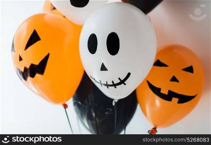 holidays, decoration and party concept - bunch of scary air balloons for halloween over white background. scary air balloons decoration for halloween party