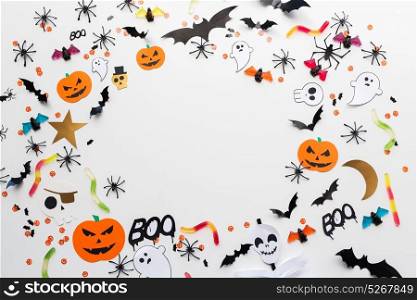 holidays, decoration and party concept - halloween paper decorations and sweets with blank copy space over white background. halloween party paper decorations and sweets