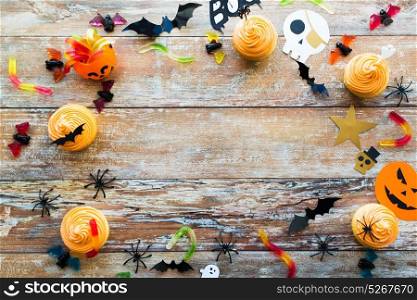 holidays, decoration and party concept - halloween paper decorations and treats with blank copy space over white background. halloween party paper decorations and treats