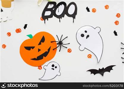holidays, decoration and party concept - halloween paper decorations over white background. halloween party paper decorations
