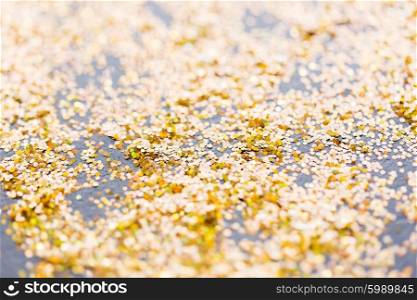 holidays, decoration and texture concept - golden glitter or yellow sequins background