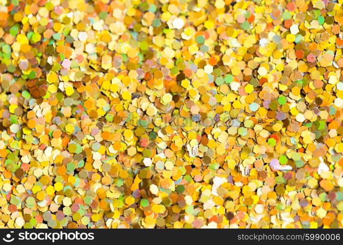 holidays, decoration and texture concept - golden glitter or yellow sequins background