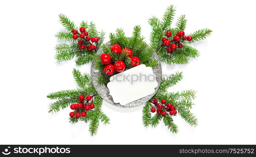 Holidays decoration. Christmas tree branches with red berry and greetings card