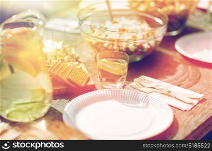 holidays, eating, mealtime and food concept - table with dinner at summer garden party. table with food for dinner at summer garden party