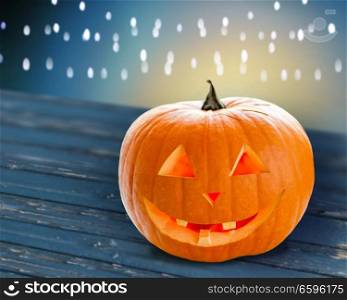 holidays, halloween and decoration concept - close up of carved pumpkin on table. close up of halloween pumpkin on table