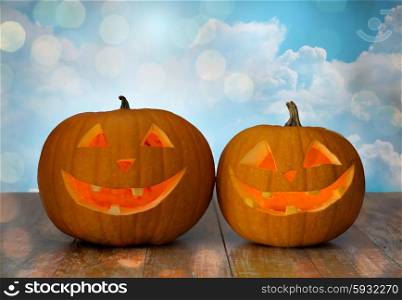 holidays, halloween and decoration concept - close up of carved pumpkins on table