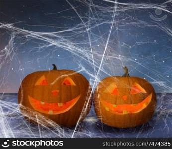 holidays, halloween and decoration concept - two pumpkins or jack o lanterns on table and spiderweb over starry night sky background. two pumpkins or jack o lanterns and spiderweb