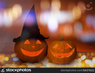 holidays, halloween, party and decoration concept - close up of carved pumpkins on table
