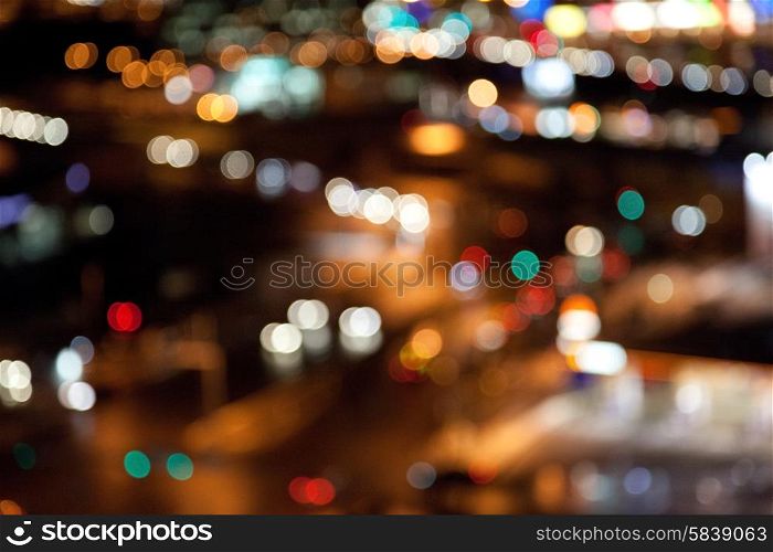 holidays, illumination and electricity concept - colorful bright lights on dark night background