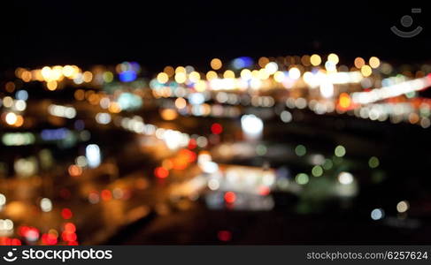 holidays, illumination and electricity concept - colorful bright lights on dark night background