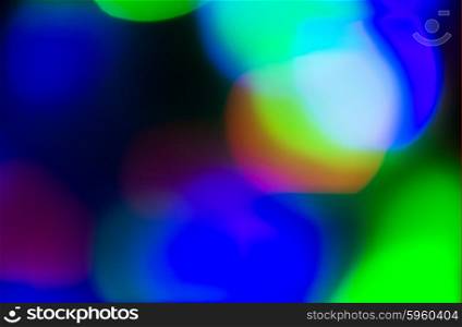 holidays, illumination and electricity concept - colorful bright night lights over black background