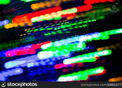 holidays, illumination and electricity concept - colorful bright night lights stream over black background