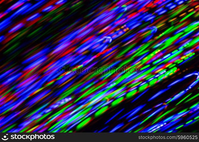holidays, illumination and electricity concept - colorful bright night lights stream over black background