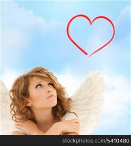 holidays, love and costumes concept - unhappy teenage angel girl over sky background