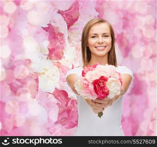holidays, love and flowers concept - young woman with bouquet of flowers