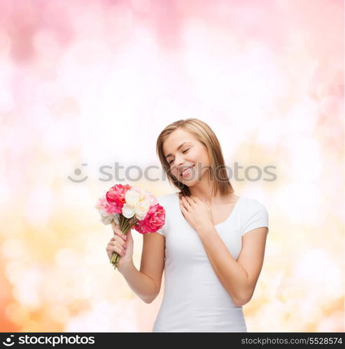 holidays, love and flowers concept - young woman with bouquet of flowers